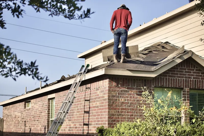 Professional roofer working on a residential roof in Top-of-the-Ridge